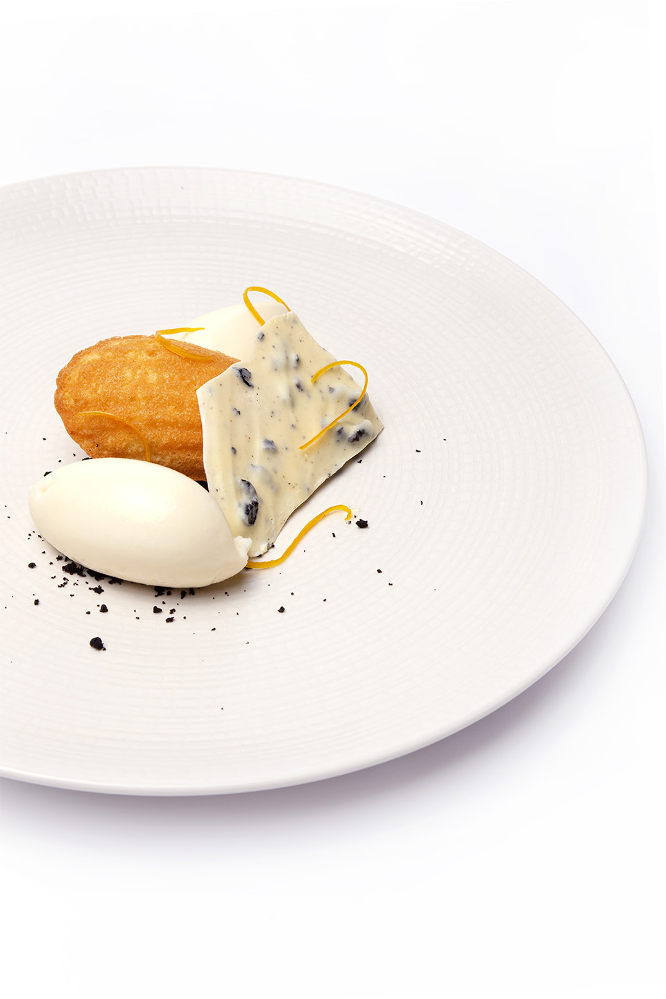 Orange madeleine with white chocolate and black olives
