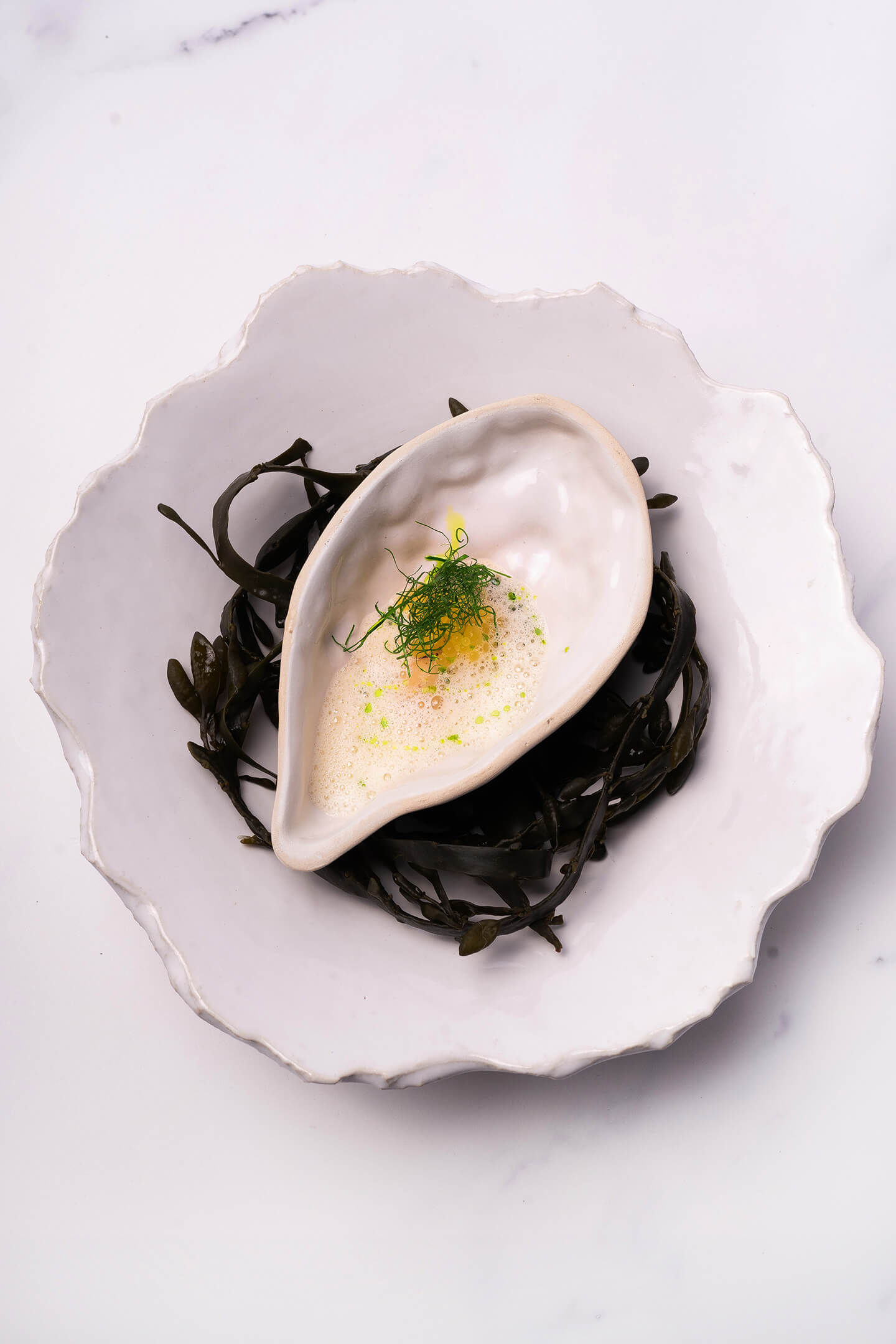 Charred oyster with whey and codium beurre blanc